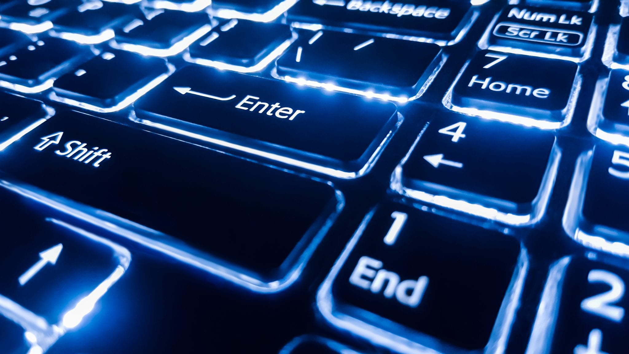 Neon keyboard with enter button. Focus on the enter button.